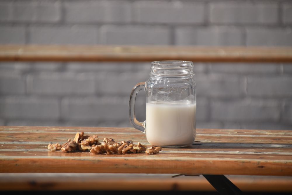 Homemade nut milk in a glass jug