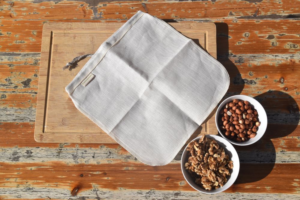 Hemp nut milk bag beside nuts